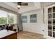 Bright office space with a ceiling fan, large window, and French doors at 318 Windrush Blvd # 10, Indian Rocks Beach, FL 33785
