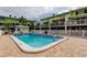 Inviting community pool surrounded by manicured grounds and condo units at 318 Windrush Blvd # 10, Indian Rocks Beach, FL 33785