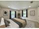 Comfortable bedroom features neutral colors, two windows, and art on the walls at 321 42Nd S Ave, St Petersburg, FL 33705