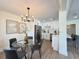 Contemporary dining room with modern light fixture and view into the updated kitchen at 321 42Nd S Ave, St Petersburg, FL 33705