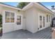 Back of house showcasing a gray deck with white doors and windows at 3220 W San Pedro St, Tampa, FL 33629