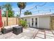 Backyard area with patio, privacy fence, plants, and a detached office or bedroom at 3220 W San Pedro St, Tampa, FL 33629
