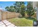 Backyard showcasing a grass lawn and a new, modern wood fence for enhanced privacy at 3220 W San Pedro St, Tampa, FL 33629