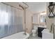 Bathroom featuring a vintage-style bathtub, vanity, toilet, and updated fixtures at 3220 W San Pedro St, Tampa, FL 33629
