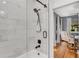 Bathroom with a modern shower featuring white marble-style tiling and bronze fixtures at 3220 W San Pedro St, Tampa, FL 33629