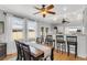Open-concept dining area featuring a wooden table set and bar stools overlooking the kitchen at 3220 W San Pedro St, Tampa, FL 33629