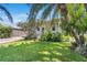 Charming home exterior features lush landscaping, a brick driveway, and a quaint front porch at 3220 W San Pedro St, Tampa, FL 33629