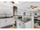 Updated kitchen with white cabinetry, granite countertops, stainless steel appliances, and hardwood floors at 3220 W San Pedro St, Tampa, FL 33629