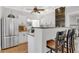 Bright, renovated kitchen featuring white cabinets, stainless steel appliances, and a breakfast bar at 3220 W San Pedro St, Tampa, FL 33629