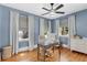 Bright office space with wood floors, blue walls, a ceiling fan, natural light, and a wooden desk at 3220 W San Pedro St, Tampa, FL 33629