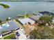 Aerial shot highlighting a waterfront home with lush landscaping and a private boat dock at 3290 Sunset N Dr, St Petersburg, FL 33710