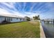 Expansive backyard with lush lawn, waterfront, and boat dock, perfect for outdoor living at 3290 Sunset N Dr, St Petersburg, FL 33710