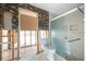 Bathroom undergoing renovation with a framed shower, toilet, and charming wallpaper at 3290 Sunset N Dr, St Petersburg, FL 33710