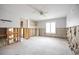 Spacious bedroom featuring a ceiling fan, window, and an open closet, undergoing renovations at 3290 Sunset N Dr, St Petersburg, FL 33710