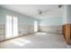 Spacious bedroom featuring shuttered windows, a ceiling fan, and walls being renovated at 3290 Sunset N Dr, St Petersburg, FL 33710