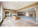 Large living room showcasing tile flooring, a ceiling fan, and a bright, open floor plan awaiting renovations at 3290 Sunset N Dr, St Petersburg, FL 33710