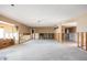 Large living room ready for renovation, featuring exposed framing, spacious layout, and potential for customization at 3290 Sunset N Dr, St Petersburg, FL 33710