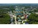 An aerial view of a neighborhood with lush greenery, several ponds, and well-maintained homes at 3353 Wedgewood Way, Tarpon Springs, FL 34688