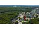 An aerial view of a lovely neighborhood with many trees and ponds that offer a serene atmosphere at 3353 Wedgewood Way, Tarpon Springs, FL 34688