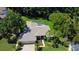 Aerial view of home, features lush landscaping, mature trees and sprawling lawn at 3353 Wedgewood Way, Tarpon Springs, FL 34688