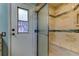 Modern bathroom featuring glass-enclosed shower with built-in bench and decorative mosaic tile accents at 3353 Wedgewood Way, Tarpon Springs, FL 34688