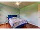 Bedroom features a stylish blue bed frame and hardwood floors at 3353 Wedgewood Way, Tarpon Springs, FL 34688