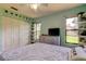 Comfortable bedroom with updated windows, a full closet, and soft natural light at 3353 Wedgewood Way, Tarpon Springs, FL 34688