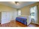 Bedroom furnished with convertible daybed and classic white armoire at 3353 Wedgewood Way, Tarpon Springs, FL 34688