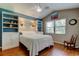 Bedroom with a window, ceiling fan, and an accent wall with built-in shelving at 3353 Wedgewood Way, Tarpon Springs, FL 34688