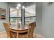 Cozy dining area featuring a round table, charming chairs, and views of the outdoor pool at 3353 Wedgewood Way, Tarpon Springs, FL 34688