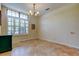 Bright dining room featuring tile floors, modern lighting, and a window with plantation shutters at 3353 Wedgewood Way, Tarpon Springs, FL 34688