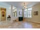 Open foyer featuring tiled floors, a decorative cabinet, and a chandelier lighting fixture at 3353 Wedgewood Way, Tarpon Springs, FL 34688