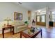 Inviting foyer showcasing tiled floors, a stylish front door, and a comfortable sofa at 3353 Wedgewood Way, Tarpon Springs, FL 34688