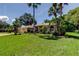 Charming home with well-manicured lawn, lush landscaping, and inviting curb appeal at 3353 Wedgewood Way, Tarpon Springs, FL 34688