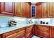 Charming kitchen featuring granite countertops, custom wood cabinets, and designer touches at 3353 Wedgewood Way, Tarpon Springs, FL 34688