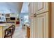 Open-concept kitchen with a breakfast bar that overlooks the dining and living spaces at 3353 Wedgewood Way, Tarpon Springs, FL 34688