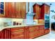 Gourmet kitchen featuring custom cabinets, granite countertops, and modern stainless steel appliances at 3353 Wedgewood Way, Tarpon Springs, FL 34688