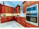 Updated kitchen with stainless steel appliances, granite countertops, and custom cabinets at 3353 Wedgewood Way, Tarpon Springs, FL 34688
