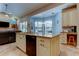 Open kitchen with an island, granite countertops, and stainless steel appliances at 3353 Wedgewood Way, Tarpon Springs, FL 34688