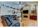 Comfortable living room featuring stone fireplace and high ceilings at 3353 Wedgewood Way, Tarpon Springs, FL 34688