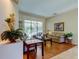 Comfortable living room with sliding glass doors leading to a screened patio and pool area at 3353 Wedgewood Way, Tarpon Springs, FL 34688