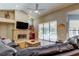 Vaulted ceiling living room featuring stone fireplace and sliding glass doors to the pool at 3353 Wedgewood Way, Tarpon Springs, FL 34688