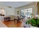 Inviting living room with hardwood floors, neutral sofas, and sliding glass doors to a screened lanai at 3353 Wedgewood Way, Tarpon Springs, FL 34688