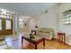 Spacious living room featuring tiled floors, a comfortable sofa, and an open layout at 3353 Wedgewood Way, Tarpon Springs, FL 34688