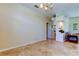 Open living space with tile flooring, neutral paint, and access to other rooms at 3353 Wedgewood Way, Tarpon Springs, FL 34688