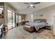 Inviting bedroom featuring a wicker bed frame, sliding doors, and natural light at 3353 Wedgewood Way, Tarpon Springs, FL 34688