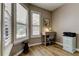 Cozy office space with wood floors, a desk, and bright windows with plantation shutters at 3353 Wedgewood Way, Tarpon Springs, FL 34688