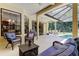 Covered patio featuring comfortable seating with views of the pool at 3353 Wedgewood Way, Tarpon Springs, FL 34688
