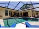 This backyard features a covered pool, great for enjoying the outdoors with Gathering and friends at 3353 Wedgewood Way, Tarpon Springs, FL 34688