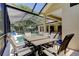 Covered patio with dining set, adjacent to a sparkling pool and tranquil outdoor living at 3353 Wedgewood Way, Tarpon Springs, FL 34688